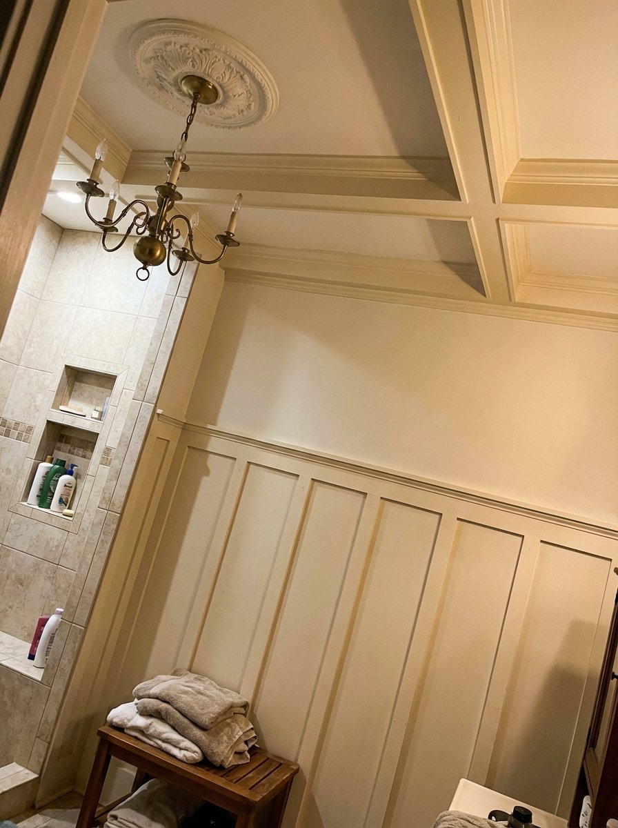 Bathroom with board-and-batten wainscoting, coffered ceiling, chandelier, and architectural details